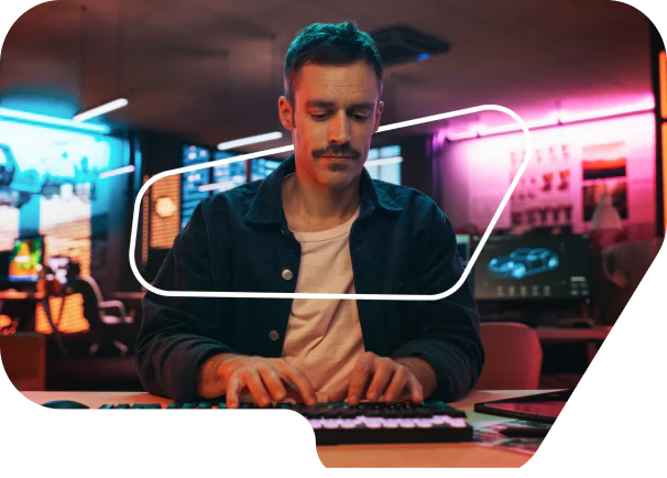 Man with mustache typing on keyboard in a neon-lit office with screens in the background. Man with mustache typing on keyboard in a neon-lit office with screens in the background.